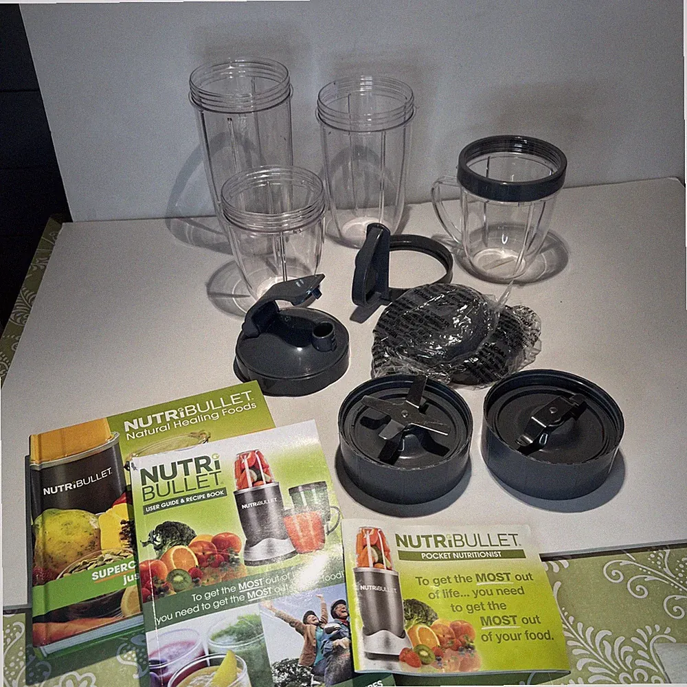 Large 11 Pc lot of Nutribullet replacement parts cups, blade, lids, handles Book